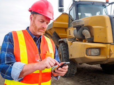 Contractor using phone on jobsite