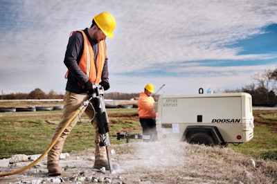 construction worker using doosan's P185-VHP165 on site