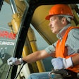 construction worker operating excavator