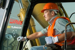 construction worker operating excavator