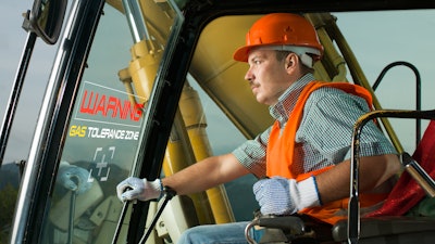 construction worker operating excavator