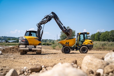 Mecalac 15MWR wheeled excavator loading
