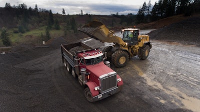 Caterpillar 980XE wheel loader loading truck