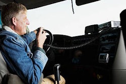 man in drivers seat of truck