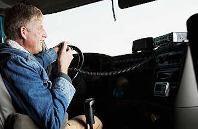 man in drivers seat of truck