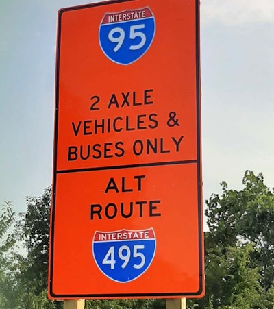 Orange sign with I-95 2 Axle vehicles & buses only on top and alt route I-495 on bottom