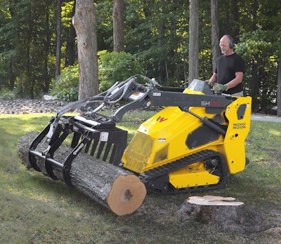 Wacker Neuson SM100 being used to pickup a log