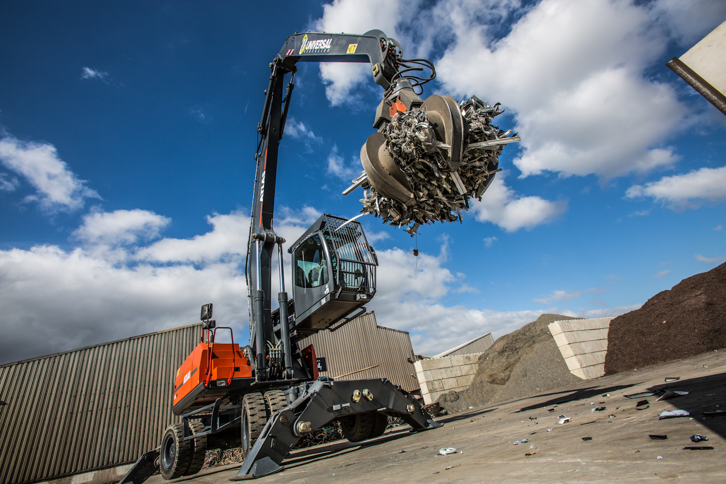 Atlas material handler picking up pieces of metal