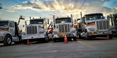 H&E Equipment Services trucks parked in a row