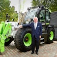 Lord Bamford stands next to JCB hydrogen-powered construction equipment