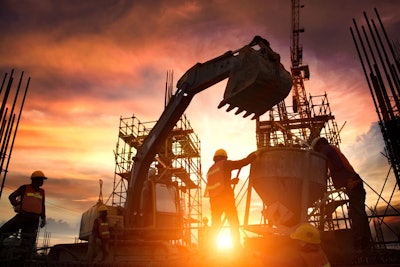 Construction workers and an excavator on a jobsite