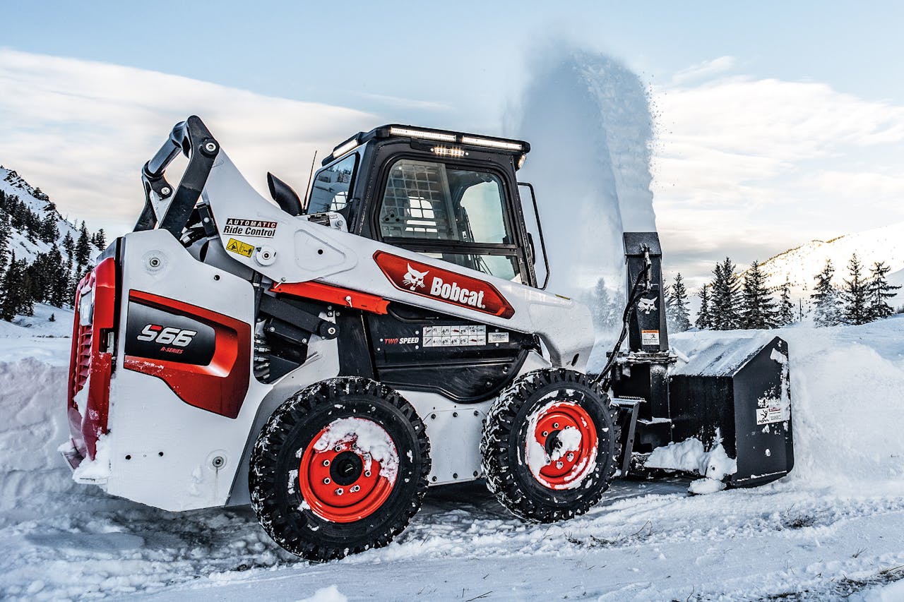 Bobcat Snowblower on skid steer clearing snow