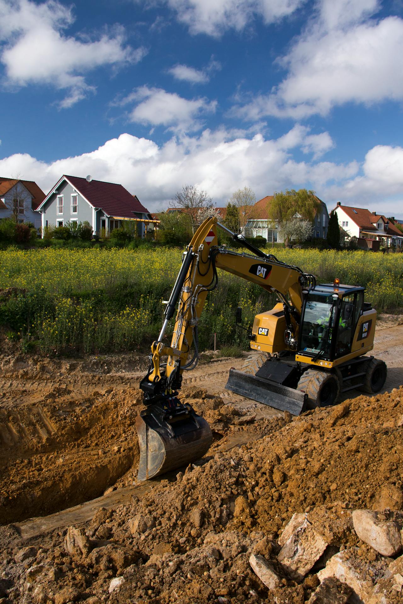 Cat excavator with tiltrotator attachment.