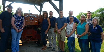 The International TD6 dozer that Willie and Russ Delauter used when starting W.F. Delauter now sits at the entrance to the firm and serves as the backdrop in this company photo.