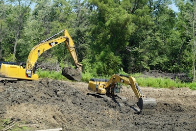 Tandem excavators at work on a $4 million U.S. Army Corps of Engineer job along the Ohio River.