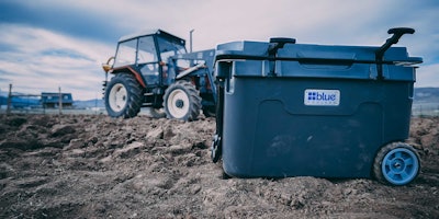 Blue Coolers' 55-quart ice vault cooler at a construction site.