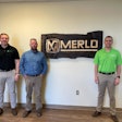 Brooks Tractor representatives stand in front of Merlo sign.