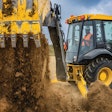Deere 310 X-tier E-Power backhoe dumping dirt