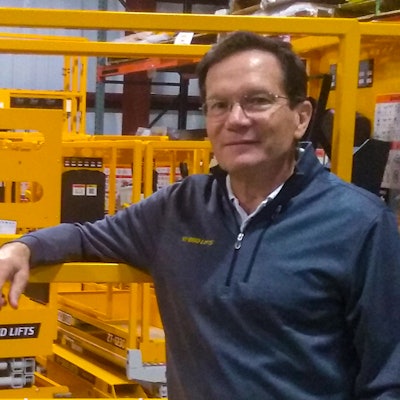 Jay Sugar next to Hy-Brid Lift scissor lift.