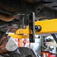 Technician uses Mob Armor phone mount while working on a truck.