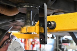 Technician uses Mob Armor phone mount while working on a truck.
