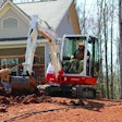 Takeuchi’s TB240 compact excavator working at a jobsite.