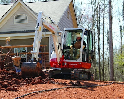 Takeuchi’s TB240 compact excavator working at a jobsite.