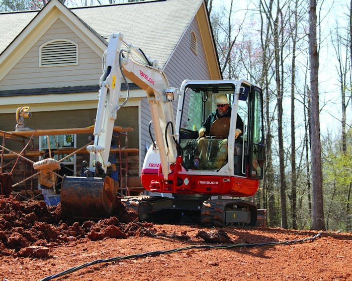 Takeuchi’s TB240 compact excavator working at a jobsite.