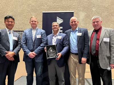 Hyundai Construction Equipment Americas leadership give award to National Equipment Dealers