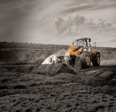 LiuGong 856H wheel loader scooping dirt on a construction site.