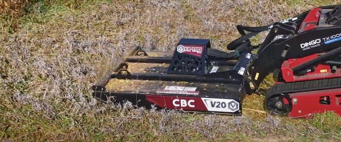 Virnig brush cutter attached to a mini skid steer