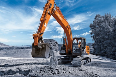 Hitachi ZX210LC excavator digging on a construction site.