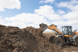 Case Wheel Loader dumps dirt in a pile