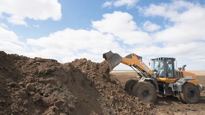 Case Wheel Loader dumps dirt in a pile