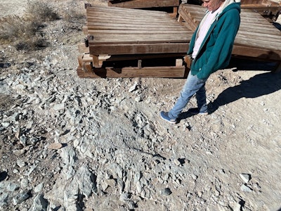 A pile of the ripped apart boardwalk lies within feet of a portion of the tracksite.