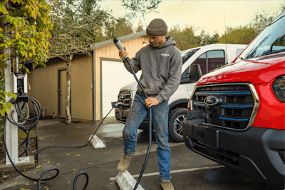 Plugging an E-Transit into a charging outlet