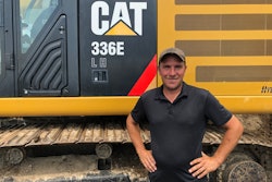 Jason Guelig Excavating owner with Cat excavator