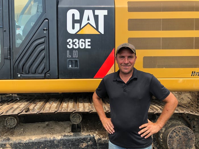 Jason Guelig Excavating owner with Cat excavator