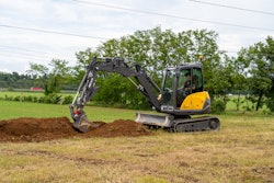 Mecalac compact excavator digging in the dirt.
