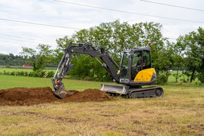 Mecalac compact excavator digging in the dirt.