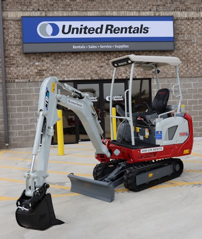 Takeuchi TB20e electric compact excavator parked in front of a United Rentals store.
