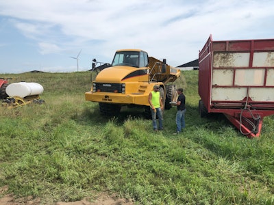 Jason Guelig talks with dump truck driver