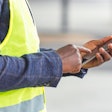 Contractor holding a mobile phone