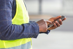 Contractor holding a mobile phone