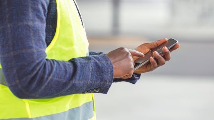 Contractor holding a mobile phone