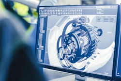 Engineer looking at an engine design on a computer screen.