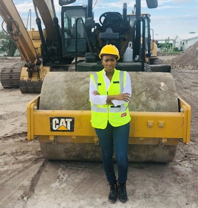 Jennifer Todd, owner, LMS General Contractors standing next to a Cat roller.