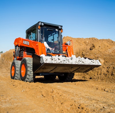 Kubota SSV75 skid steer hauling rocks