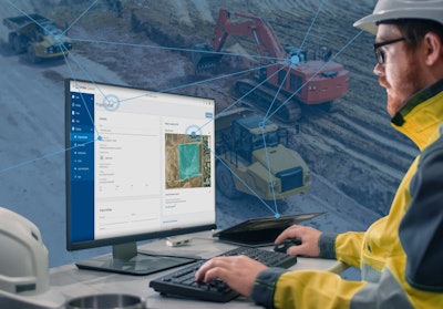 Construction worker viewing jobsite models on a computer.