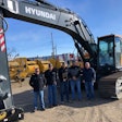 West River Equipment management team stands in front of Hyundai excavator